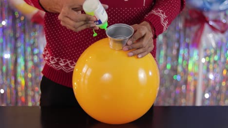 crafting a big yellow ball, as part of making christmas ornaments