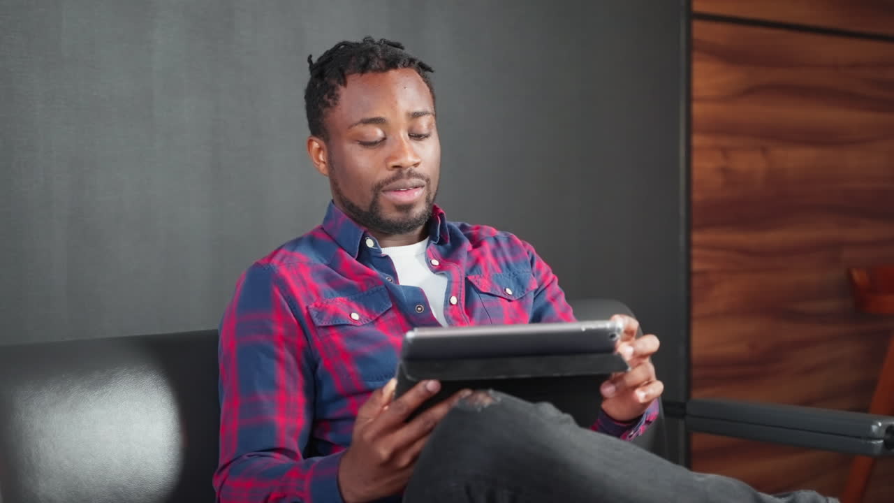 Man using a tablet on a couch