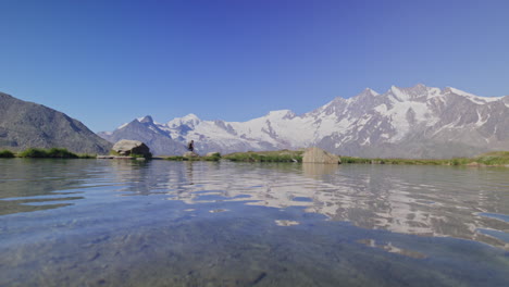 two hikers explore saas-fee, saas-balen, and the saas-almagell dam, passing waterfalls, marmots, and alpine peaks in a breathtaking high-mountain landscape.