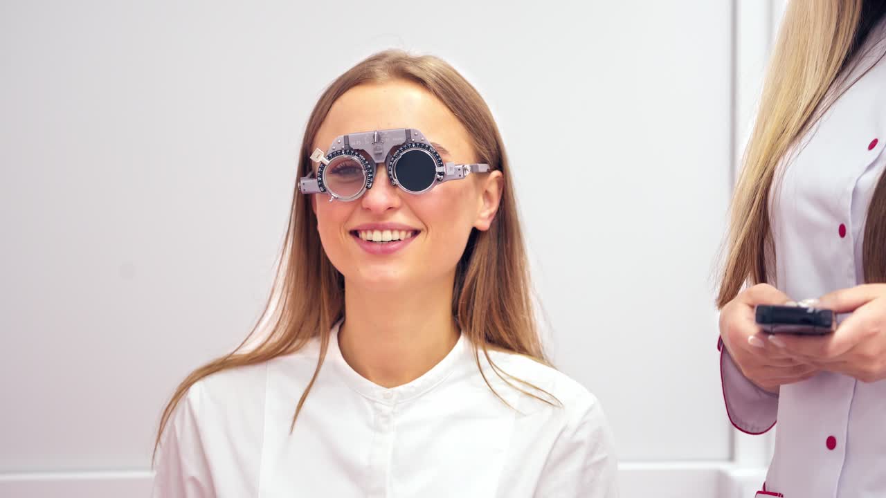 Patient in ophthalmology clinic. Woman patient with phoropter in optician office
