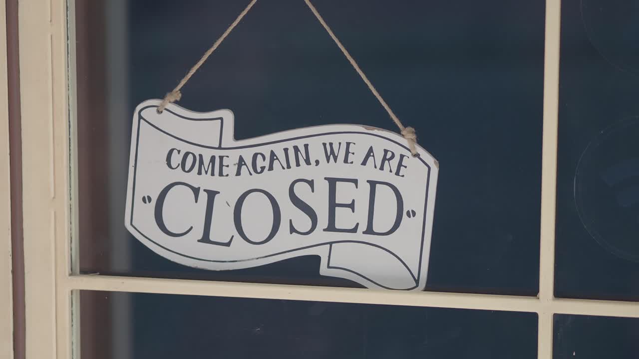 A 'CLOSED' sign displayed on a shop window