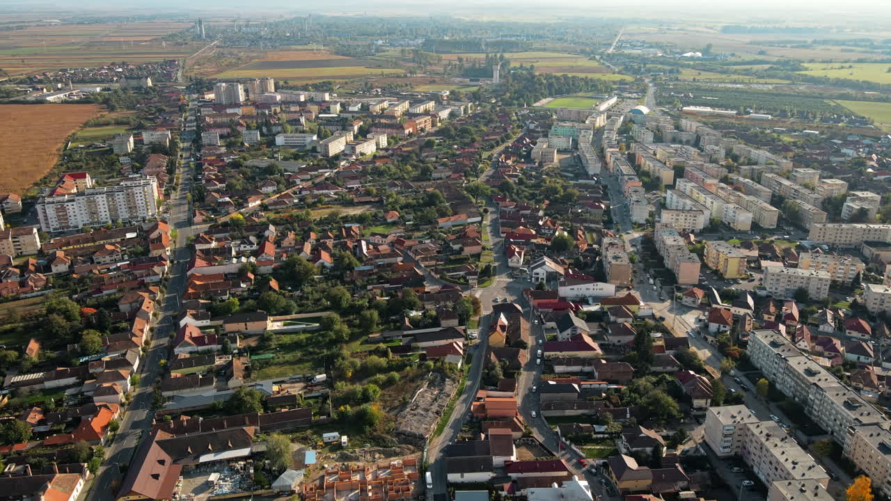 Aerial drone view of the Fagaras, Romania. Multiple residential buildings, roads with cars, greenery