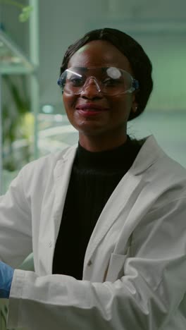 african american scientist adjusting safety goggles in a laboratory