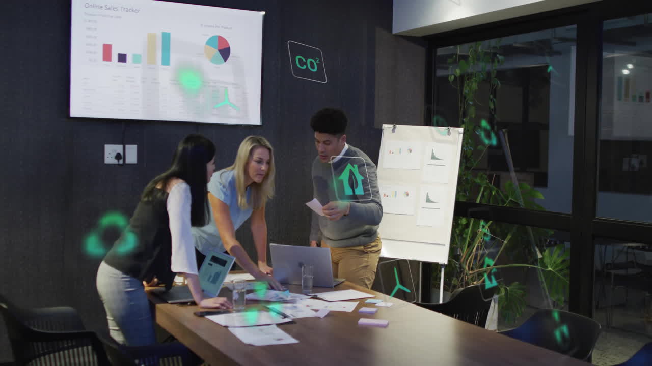 In office, diverse team collaborating on sales data with animation overlay