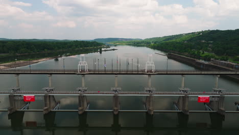 fly over big dam bridge gates over arkansas river in cook's landing park, north little rock, arkansas usa