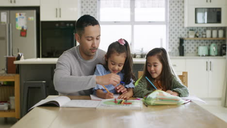 father helping daughters with homework