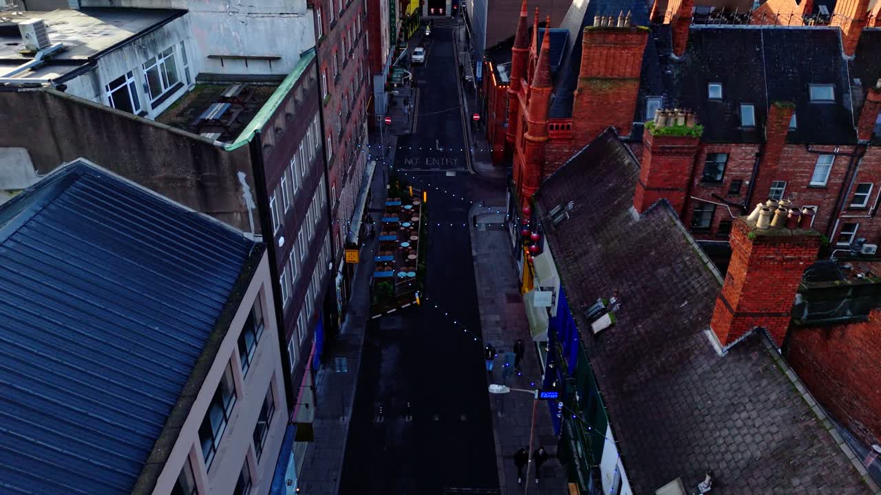 aerial cinematic drone shot going down the capital of Ireland, Dublin's famous Drury street. With bustling roads and streets filled with tourists and locals alike with seagulls flying past at sunrise