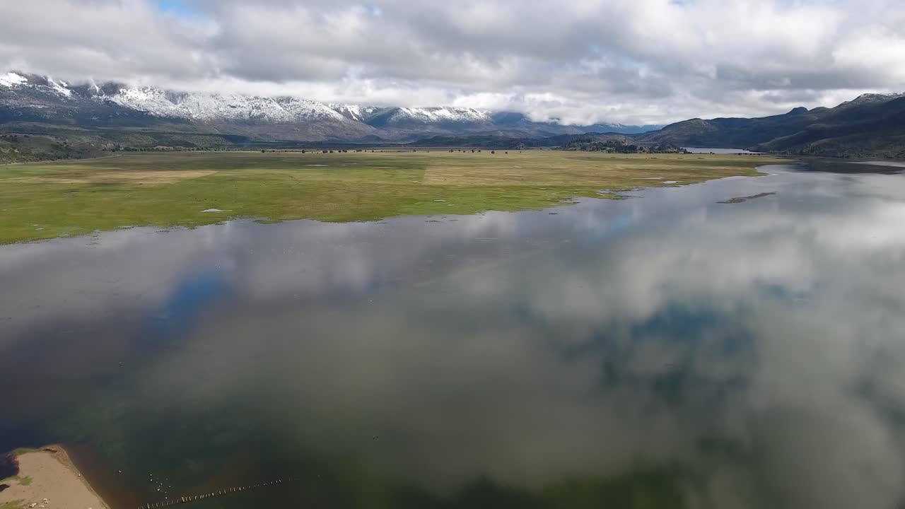 Beautiful aerial of Andes mountains a lake and pasture land near Los Alerces National Park 1