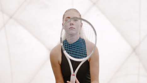 Half-portrait-of-focused-young-Caucasian-female-tennis-player-preparing-for-a-serve.-120-FPS-slow-motion,-4K-UHD-RAW-graded-footage