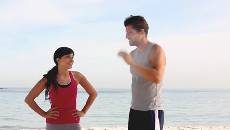 couple of joggers running on the beach