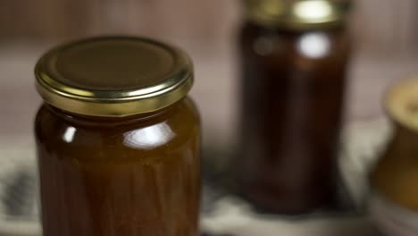 Close-up-of-rotating-mason-jar-of-peach-jam