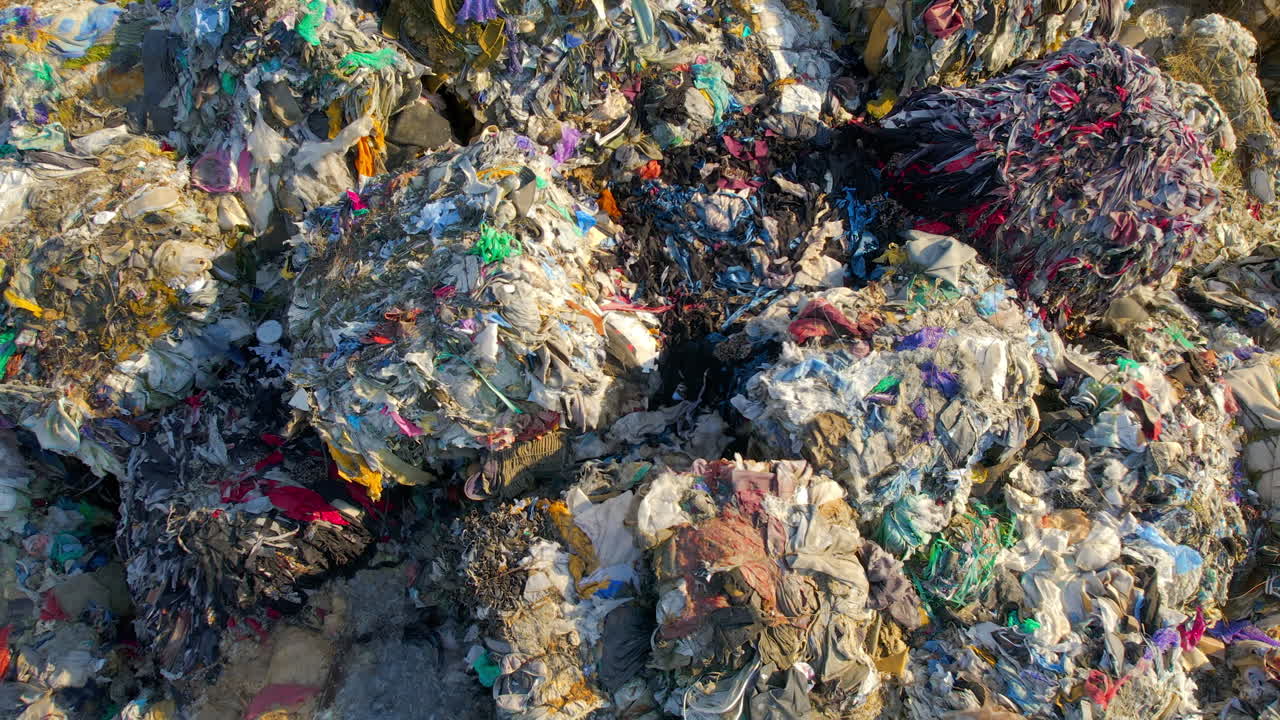 Drone view of huge heaps of pressed garbage at waste sorting plant. Slow motion