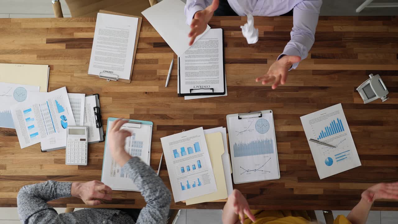 Overhead view of a business team discussing financial data and documents