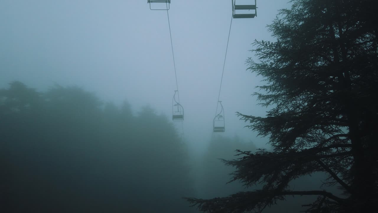 View of old telefrick cabins inside forest, foggy weather, in chrea national park - algeria