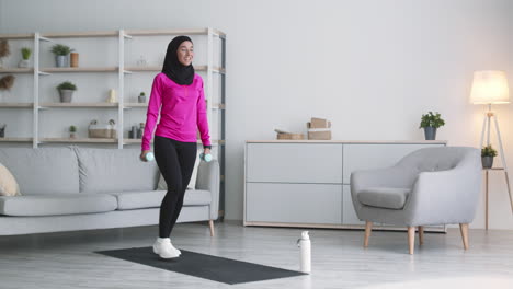 woman working out at home with dumbbells