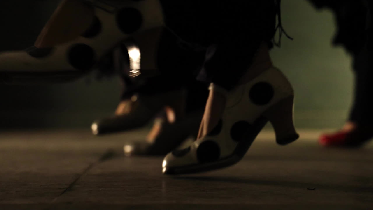 Close up gimbal shot of feet doing flamenco tap dancing. Low POV
