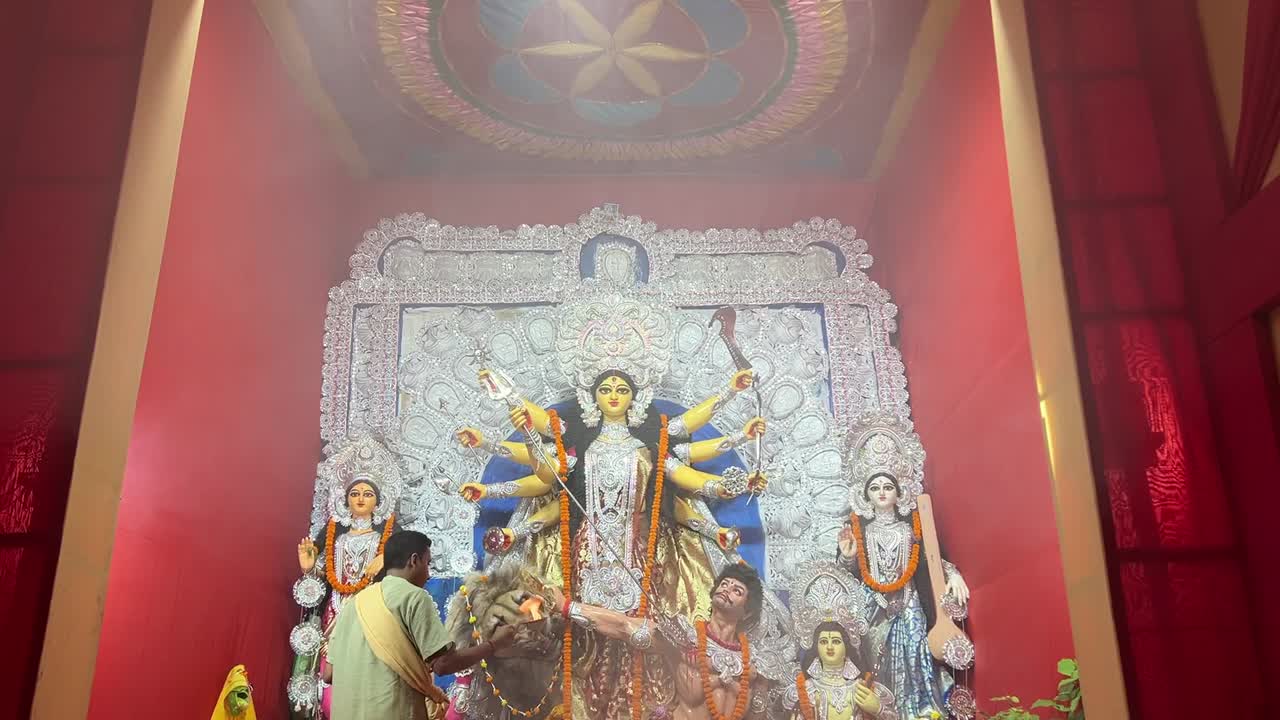 Priest performing Sandhya Arti at a Durga Puja Pandal in Kolkata