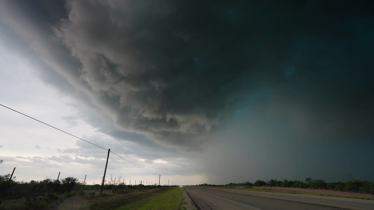 Dark storm moving closer over road as sky turns dark