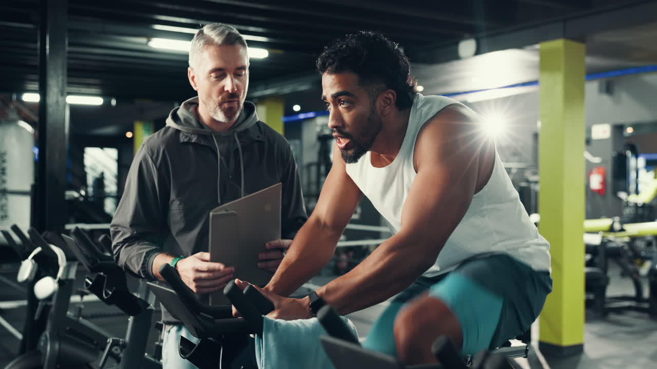 Man working out with personal trainer at the gym