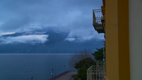 time lapse of fog rolling over mountains with a hotel balcony in the foreground