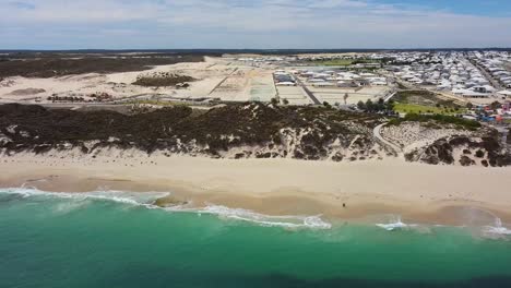 Aerial-flyover-beach-towards-lookout-tower,-Amberton-Beach---Perth-Australia