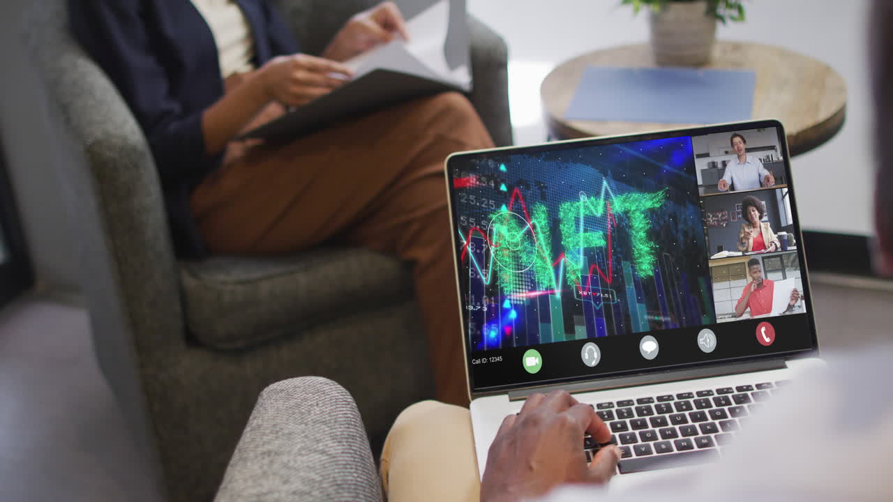 African american businessman using laptop for video call with diverse business colleagues