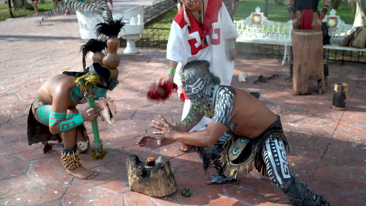 Mayan dancers performing to live drums outside in a park in Valladolid, Mexico