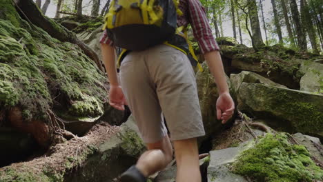 a young healthy man climbs up a steep mountain path adventures and an active lifestyle