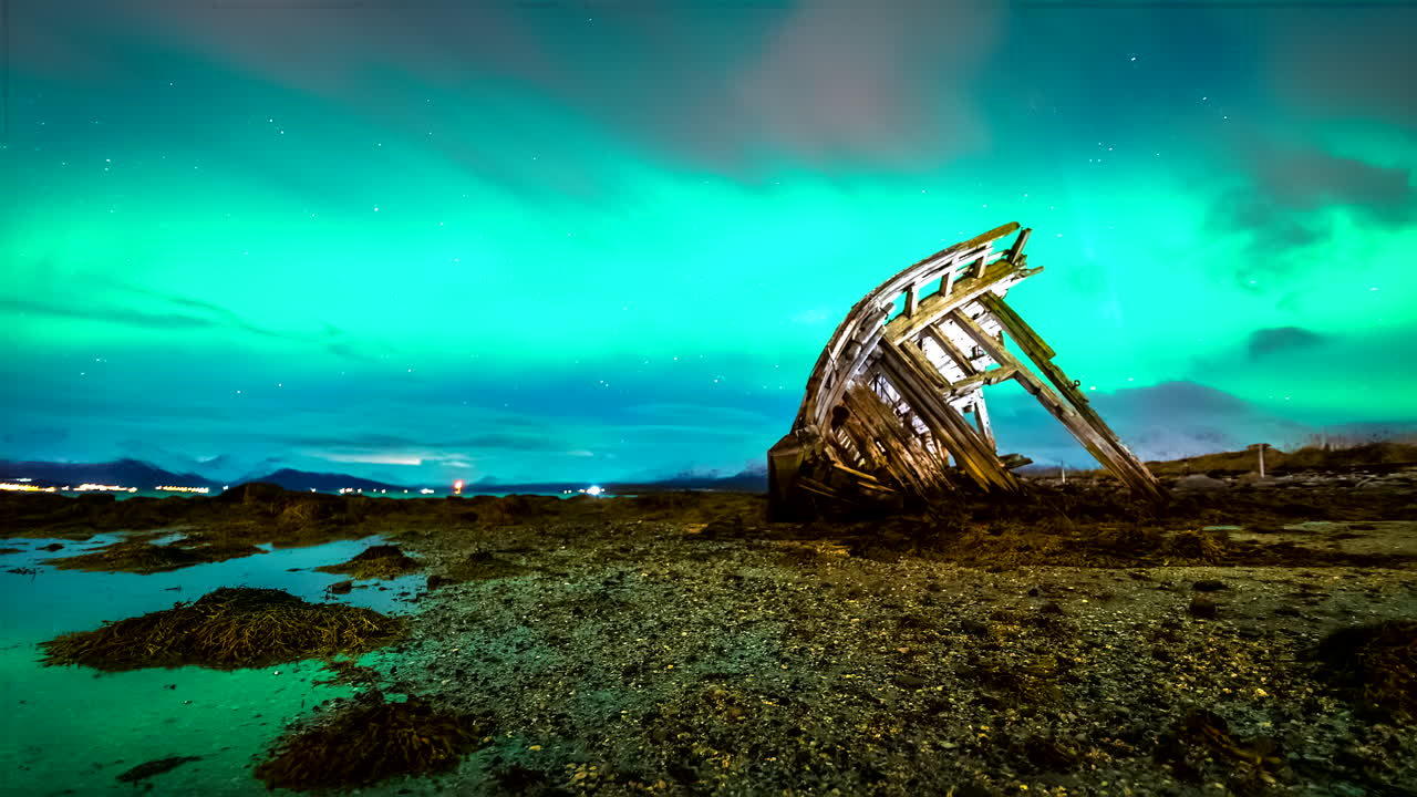Motion timelapse of blue northern lights in Norway sky over Tisnes shipwreck