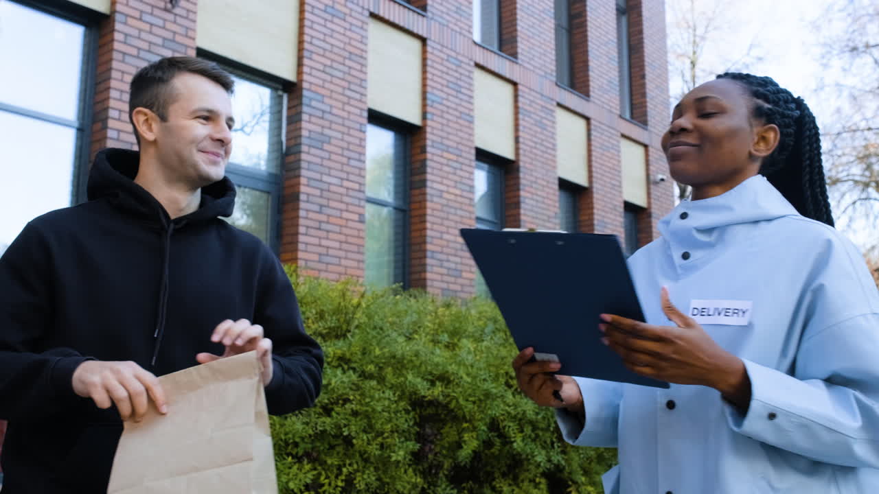 Delivery girl with paper bag and a clipboard