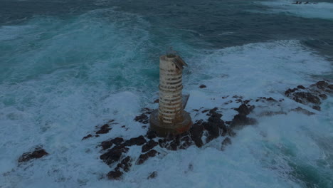 mangiabarche lighthouse: close-up aerial view of this beautiful lighthouse on the island of sardinia during sunset