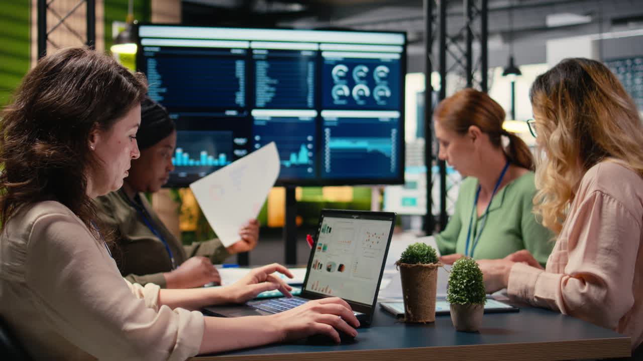 Vertical Video Focused businesswoman analyzing graphs and data on laptop at the table