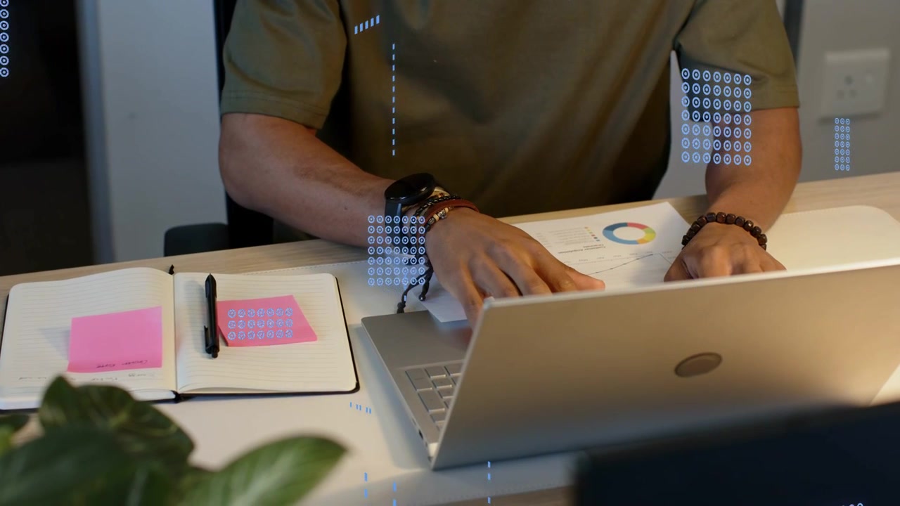 Man at laptop checking pie chart, moving notes for business planning while blue overlay over hands