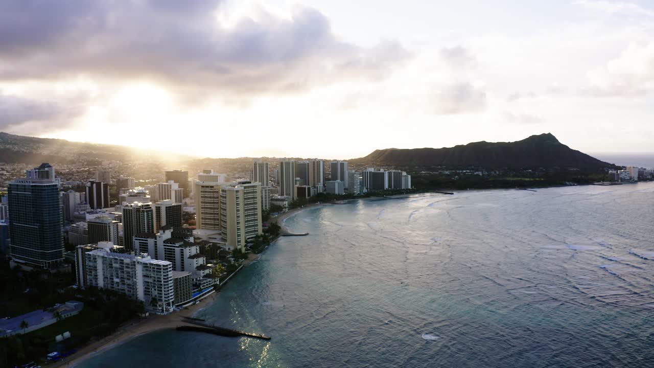 Dronen ilmakuva Oahun tiheästä rannikosta auringonlaskun aikaan, Diamond Head näkyy selvästi etäällä