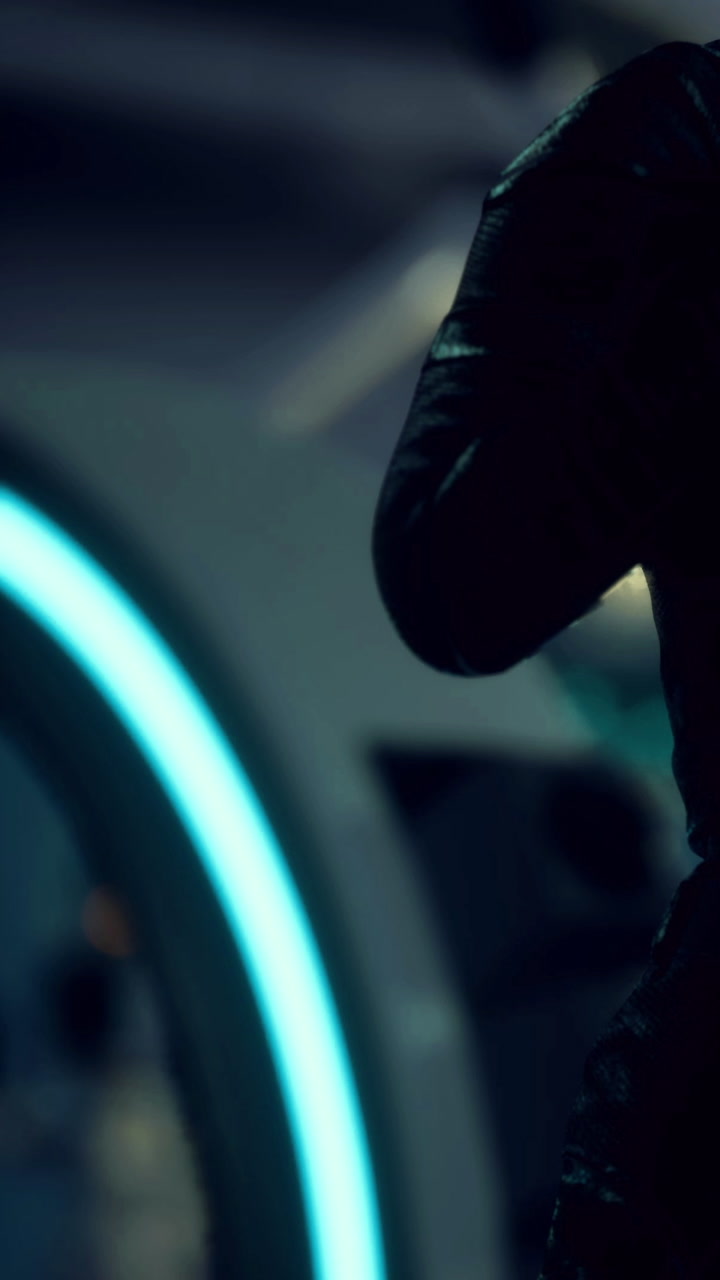 Soldier preparing for mission in futuristic command center at dawn