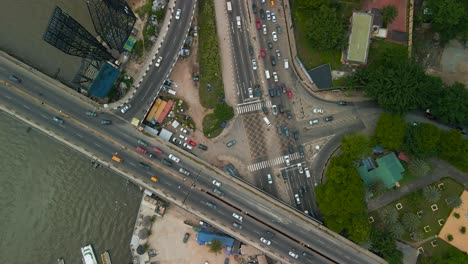 Traffic-and-cityscape-of-Victoria-Island,-Lagos,-Nigeria-featuring-Falomo-Bridge,-Lagos-Law-school-and-the-Civic-centre-tower