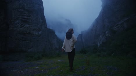 woman hiking in a misty mountain valley