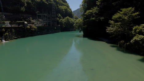 Seguimiento-Aéreo-Hacia-Atrás-Sobre-Una-Pequeña-Presa-En-La-Prefectura-De-Kochi-En-La-Isla-De-Shikoku,-Japón