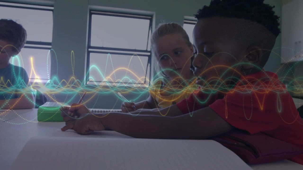 Boy in red shirt leaning and tracing tabletop causing waveform shifting while peers doing classwork