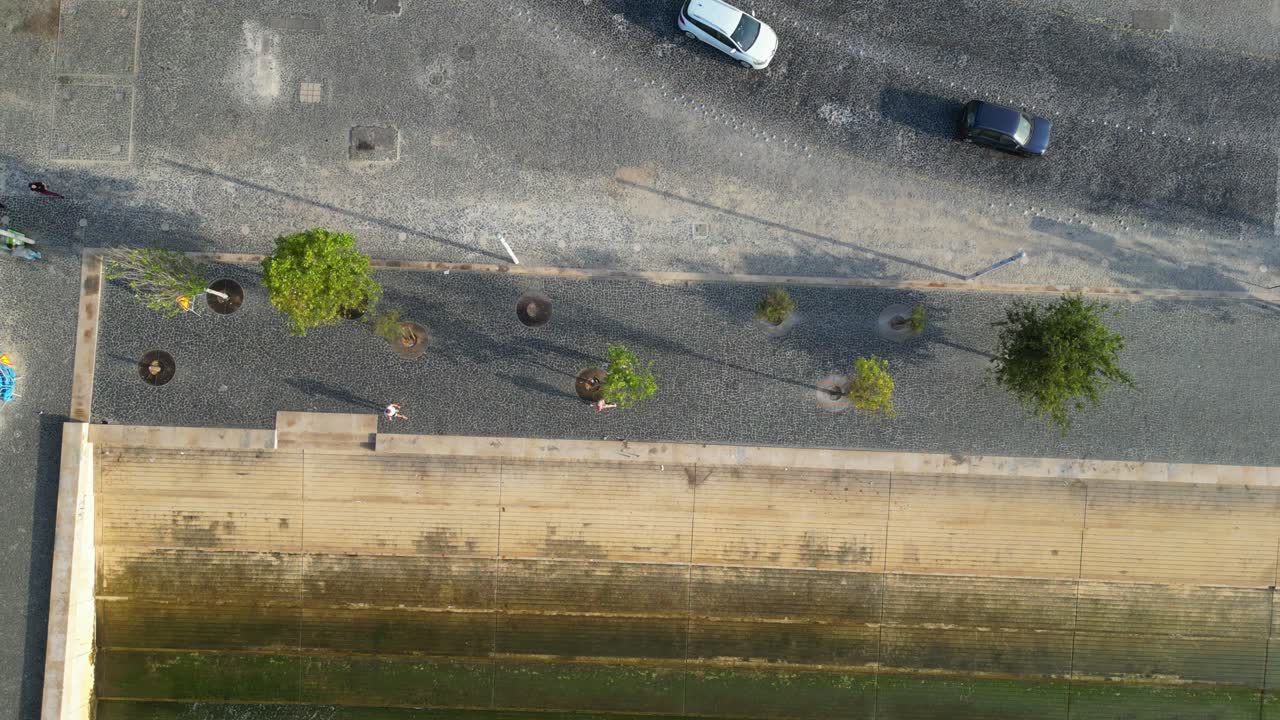 Seen from above people jogging at Lisbon riverside,Portugal