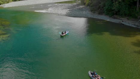 Young-people-canoeing-on-beautiful-pristine-clear-blue-Pelorus-River,-New-Zealand---Aerial-Drone