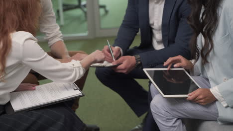 a working group of two businesswomen and two businessmen in the middle of a brainstorming session 6