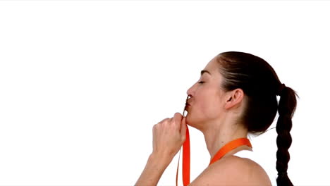 happy athlete kissing medal