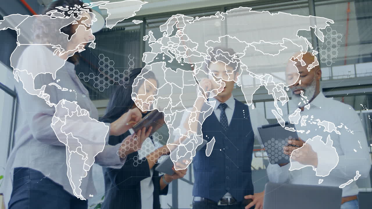 Four professionals collaborating at table, exploring business data with holographic map overlays