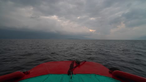 view from the bow of a boat on a cloudy lake or sea
