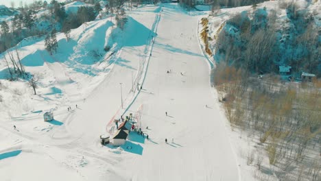 track with ski lift on snowy hill on winter day upper view