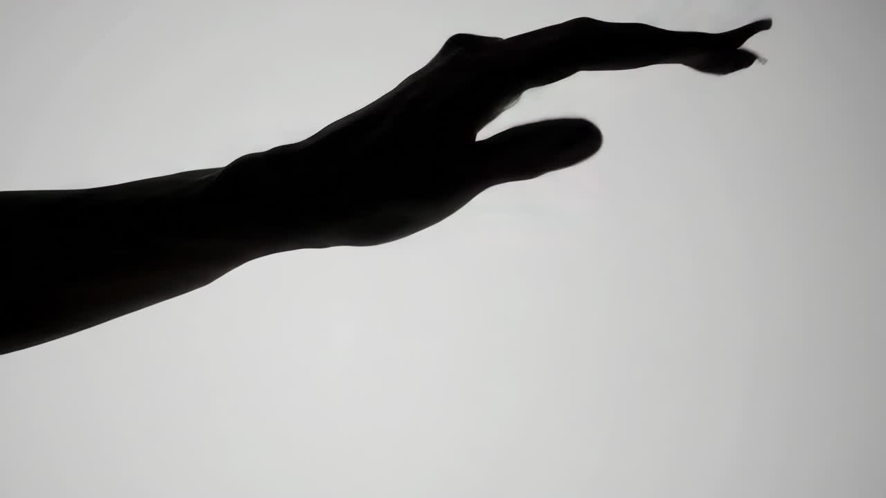 Silhouette of a Reaching Hand
