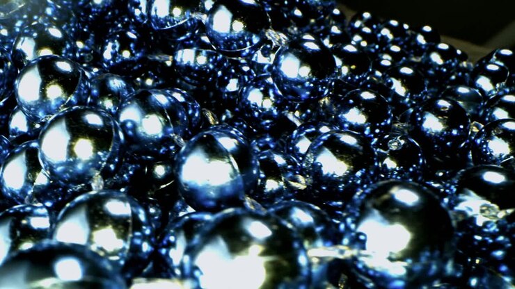 Close-up of a cluster of reflective, blue beads