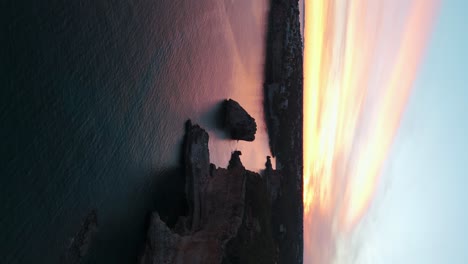 Aerial-View-Of-Coastal-Calm-Bay-Waters-With-Orange-Yellow-Sunset-Clouds-On-Horizon-In-Palma-De-Mallorca