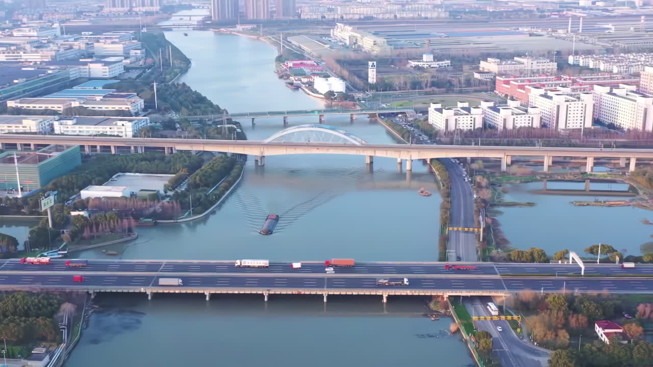 Overhead shot of industrial Big factory warehouse rooftop. Aerial drone shot camera flying forward. Factory rooftop, roof windows, ventilation shafts, flat roof of a big manufacture warehouse